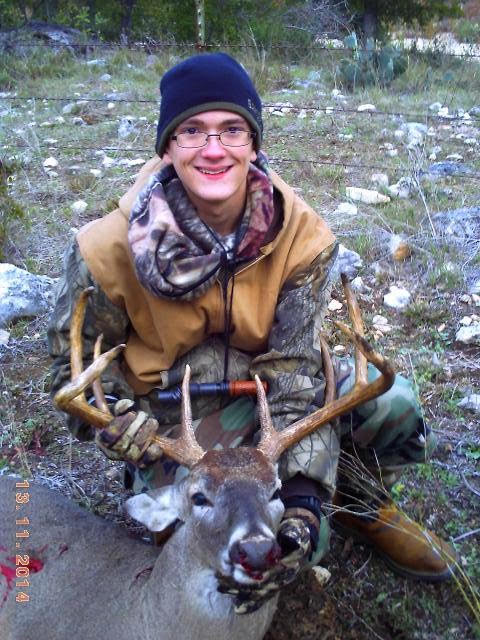 Founder Deven Wallace as a young hunter with a whitetail buck during an Operation Orphans hunt